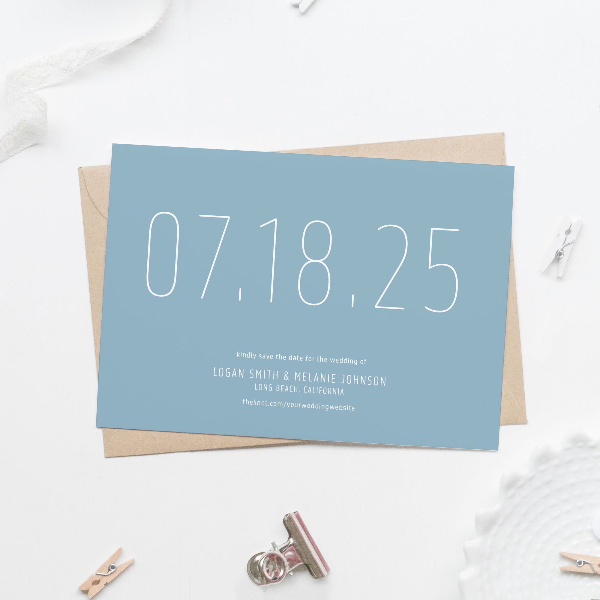 light blue save the date card in white sans serif skinny font with large date