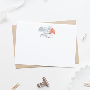 personalized stationery with watercolor red barn and snow trees with first name in light blue and last name in brown